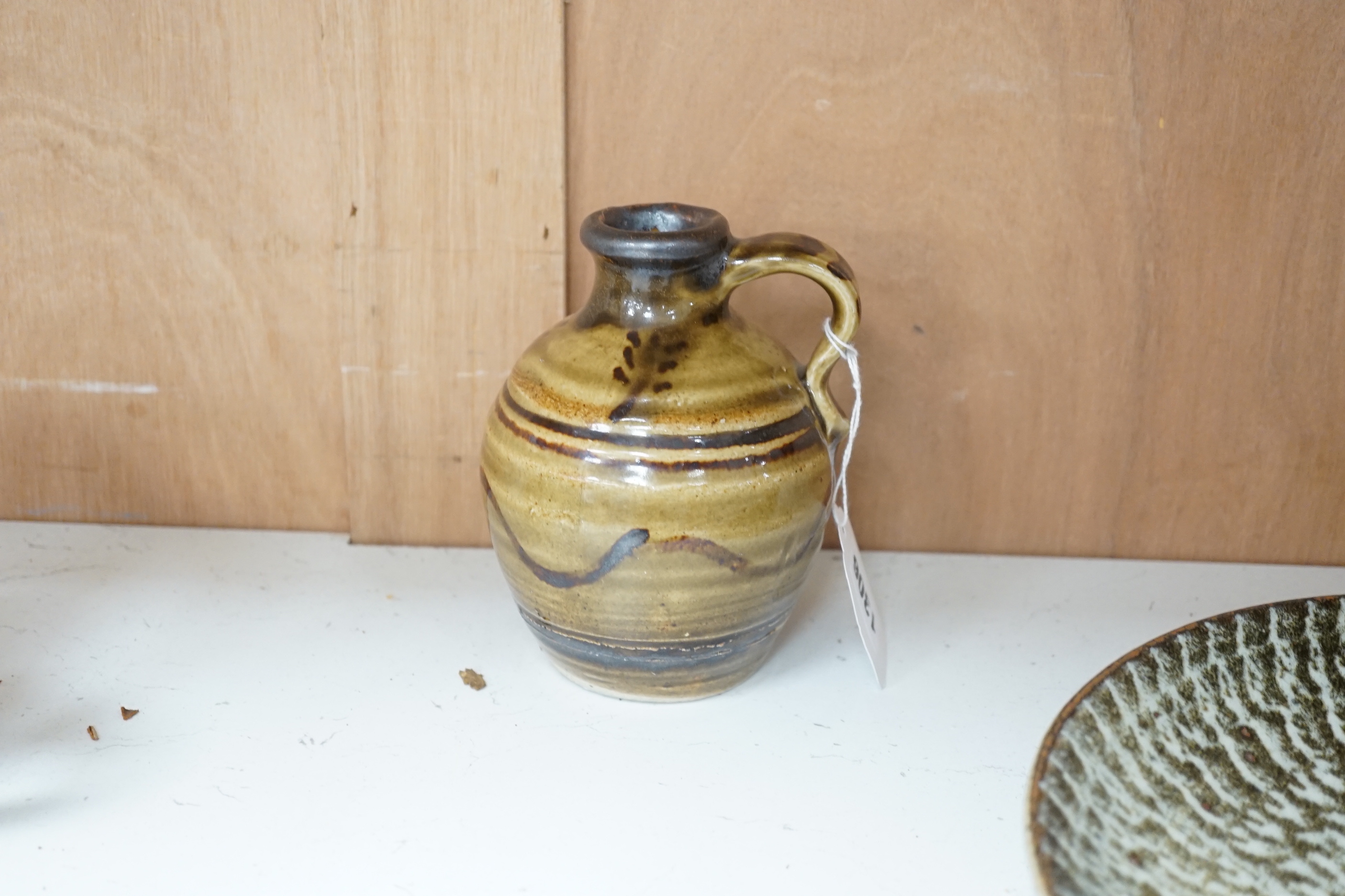 A group of European and Japanese studio pottery dishes, bowls and vases including a Boscastle R Irving plate, largest 26cm in diameter (17)